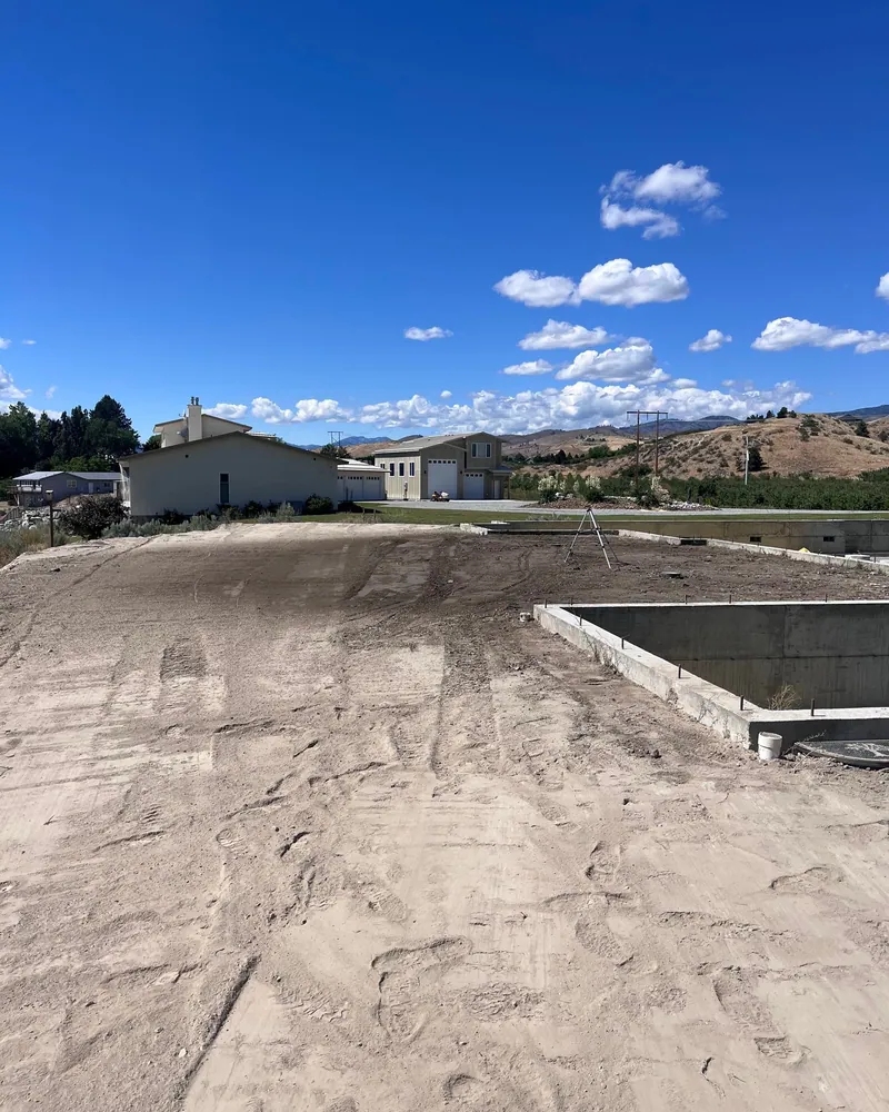 The same end graded flat and compacted with the surveyor's tripod set up on it
